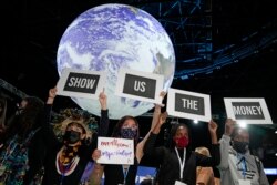 Climate activist Vanessa Nakate, second right, and other activists engage in a 'Show US The Money' protest at the COP26 U.N. Climate Summit in Glasgow, Scotland, Nov. 8, 2021.