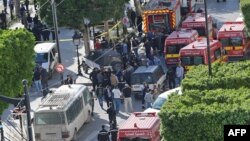 Police and firemen gather at the site of a suicide attack in the center of the Tunisian capital Tunis, Oct. 29, 2018, .
