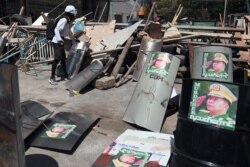 Shields with attached pictures of Myanmar's military junta leader General Min Aung Hlaing are seen during a protest against the military coup in Yangon, Myanmar, March 1, 2021.