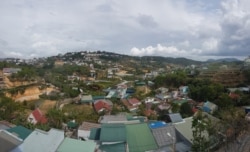 In Vietnam's less-developed towns, like Da Lat, brokers post signs offering to take locals abroad to find work. (Ha Nguyen/VOA)