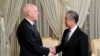 Tunisian President Kais Saied, left, shakes hands with Chinese Foreign Minister Wang Yi on Jan. 15, 2024, in Tunis. (Tunisian Presidency via AP)