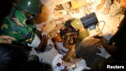 Rescue workers look for trapped garment workers at the collapsed Rana Plaza building in Savar, 30 km (19 miles) outside Dhaka, Apr. 26, 2013. 