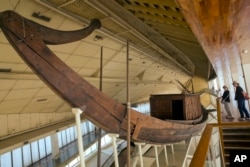 Tourists visit the ancient Pharaoh king Cheops' first solar boat, which was removed in pieces in 1954 and painstakingly reconstructed, during their visit to the boat museum at the Pyramids site in Giza, Egypt, March 29, 2017.