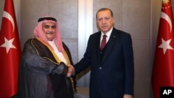 Turkey's President Recep Tayyip Erdogan, right, shakes hands with Bahrain's Foreign Minister Sheik Khalid bin Ahmed Al Khalifa prior to their meeting in Istanbul, June 10, 2017.