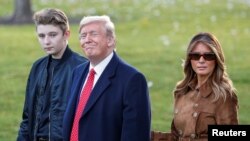U.S. President Donald Trump walks with son Barron and first lady Melania Trumpม November 26, 2019.