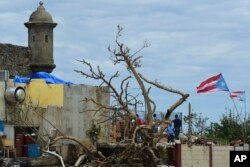 Residents at La Perla community in Old San Juan cling to their battered residences after the passing of Hurricane Maria, in San Juan, Puerto Rico, Sept. 25, 2017.