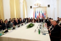 FILE - Iran's top nuclear negotiator Abbas Araqchi and Secretary General of the European External Action Service (EEAS) Helga Schmid attend a meeting of the JCPOA Joint Commission in Vienna, Austria, June 28, 2019.
