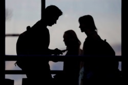 FILE - Students walk on the campus of Utah Valley University in Orem, Utah, Nov. 14, 2019.