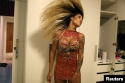 Transgender dancer Kamilla Carvalho prepares herself for the rehearsal of the Salgueiro samba school prior to the carnival parade in Rio de Janeiro, Brazil, Jan. 11, 2018.