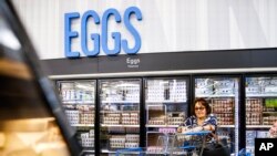 FILE - A woman buys eggs at a Walmart Superstore in Secaucus, NJ, on July 11, 2024. 