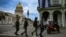 FILE - Police officers walk near the Havana Capitol, Nov. 15, 2021. The Cuban opposition planned to take to city streets that day to demand the release of political prisoners, but the Cuban government banned the demonstration.