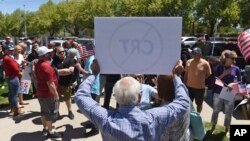 A man holds up a sign against Critical Race Theory during a protest outside a Washoe County School District board meeting in Reno, Nev. (Andy Barron/Reno Gazette-Journal via AP, File) 