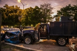 Bullet-ridden and crashed vehicles remain in a street of Culiacan, state of Sinaloa, Mexico, Oct. 17, 2019, after heavily armed gunmen in trucks fought an intense battle with Mexican security forces.
