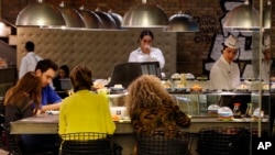 People eat sushi at a restaurant in Beirut, Lebanon, Nov. 10, 2017. Prime Minister Saad Hariri’s resignation could unravel the first steps in years toward injecting some cash and confidence in Lebanon’s anemic economy.