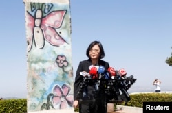 FILE - Taiwanese President Tsai Ing-Wen, standing by a section of the Berlin Wall, speaks to media at the Ronald Reagan Presidential Library in Simi Valley, California, Aug.13, 2018.