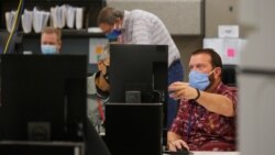 Election workers adjudicate ballots at the Maricopa County Tabulation and Election Center (MCTEC)