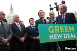 FILE - U.S. Representative Alexandria Ocasio-Cortez (D-NY) and Senator Ed Markey (D-MA) hold a news conference for their proposed Green New Deal to achieve net-zero greenhouse gas emissions in 10 years, at the U.S. Capitol in Washington, Feb. 7, 2019.