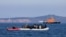 FILE - Migrants on a dinghy are approached by a Greek coast guard boat near the port of Thermi, as they crossed part of the Aegean Sea from Turkey to the island of Lesbos, Greece, March 1, 2020. 