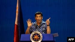 FILE - Philippine President Rodrigo Duterte gestures during the Partido Demokratiko Pilipino-LakasBayan (PDP-LABAN) meeting in Manila on May 11, 2019, ahead of Monday's the midterm elections.