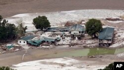 A June 23, 2013 photo shows damaged houses by the River Ganges in Guptkashi, India. 