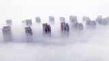 Residential buildings are shrouded in fog in Lianyungang, in eastern China's Jiangsu province, on March 12, 2025. 