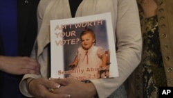 FILE - Carolyn Fortney, a survivor of sexual abuse at the hands of her family's Roman Catholic parish priest as a child, awaits legislation in the Pennsylvania Capitol to respond to a landmark state grand jury report on child sexual abuse in the Catholic Church, Wednesday, Oct. 17, 2018 in Harrisburg, Pa. (AP Photo/Marc Levy)