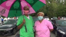 Shealese Russell-Reams, left, and Melanie Daniels, co-workers and members of Kamala Harris’ sorority, AKA, spent their lunch break hoping to catch a glimpse of the newly named VP candidate, August 12, 2020. (E. Sarai/VOA)
