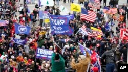 FILE - Rioters gather outside the US Capitol in Washington, on Jan 6, 2021.