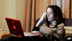 Gabriela Gonzalez, a freshman at Northwestern University, in her dorm on Dec. 9, 2007, in Evanston, Ill. (AP Photo/Jerry Lai)