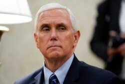 Vice President Mike Pence listens as President Donald Trump holds a meeting about the coronavirus response in the Oval Office of the White House, May 7, 2020, in Washington.