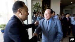 Foreign Ministers, Hor Namhong, right, of Cambodia, and Kasit Piromya, left, of Thailand, shake hands before a meeting in the Foreign Ministry in Phnom Penh, Cambodia, Thursday, Dec. 30, 2010.