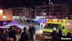 An ambulance is parked at the scene of a fatal shooting at the Quebec Islamic Cultural Centre in Quebec City, Canada, Jan. 29, 2017.