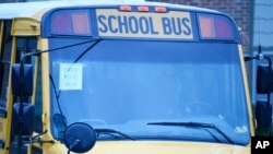 This wi-fi-enabled school bus, seen at an apartment complex on March 27, 2020, in Winnsboro, S.C., is one of many being sent to rural and lower-income areas around South Carolina to help students with distance learning during the coronavirus outbreak. (AP Photo/Meg Kinnard)