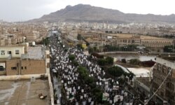FILE - Supporters of the Houthis rally to denounce the U.S. killing of Iranian military commander Qassem Soleimani and Iraqi militia commander Abu Mahdi al-Muhandis, in Sanaa, Yemen, Jan. 6, 2020.