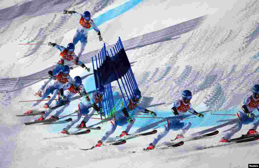 This multiple exposure image shows Austria&#39;s Benjamin Raich clearing a gate during the second run of the men&#39;s alpine skiing giant slalom event, Rosa Khutor Alpine Center, Feb. 19, 2014. 