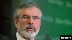 FILE - Sinn Fein's Gerry Adams holds a news conference following his release from police detention, in Belfast, May 4, 2014.