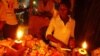 A Ugandan woman shops at a kiosk in candle light in Kampala. (file photo)