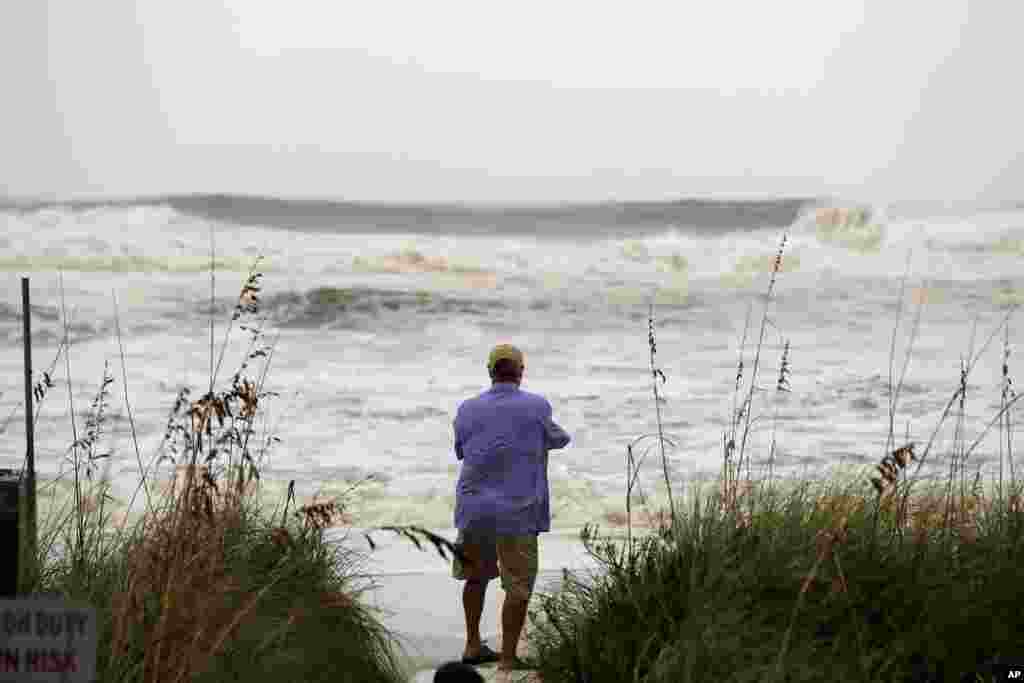People photograph the surf from encroaching Hurricane Michael, which is expected to make landfall today, in Panama City Beach, Fla., Oct. 10, 2018. 