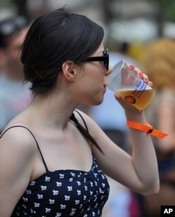 In this 2013 photo, a woman is seen consuming a beer in Turkey. That same year Turkey passed laws that restrict alcohol advertising and availability. (File Photo)