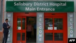 FILE - A general view shows the main entrance to Salisbury District Hospital, in Salisbury, southern England, July 4, 2018, where a British woman, Dawn Sturgess, poisoned with a nerve agent, died Sunday.