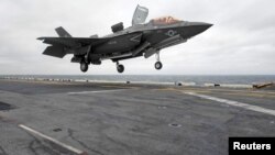 FILE - A Lockheed Martin F-35B Lightning II Joint Strike fighter jet touches down on the amphibious assault ship USS Wasp in the Indo-Asian-Pacific region in East China Sea, March 5, 2018.