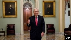 Senate Majority Leader Mitch McConnell of Ky. gives a thumbs up as he arrives on Capitol Hill, March 25, 2020, in Washington. 