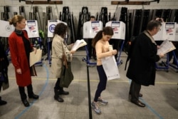 Voters wait in line to vote during the midterm election in the Brooklyn borough of New York City, November 6, 2018.