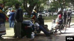 Police monitor protesters at Africa Unity Square.
