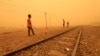 FILE - Children play near railways during a sandstorm in Khartoum, Sudan, March 29, 2018. 