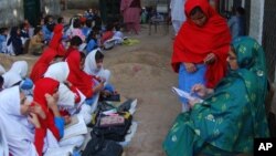 Pakistani girls attend class at a makeshift school in a small graveyard in Gujranwala near Lahore, Pakistan on Friday, Nov 25, 2011. (AP Photo/Aftab Rizvi)