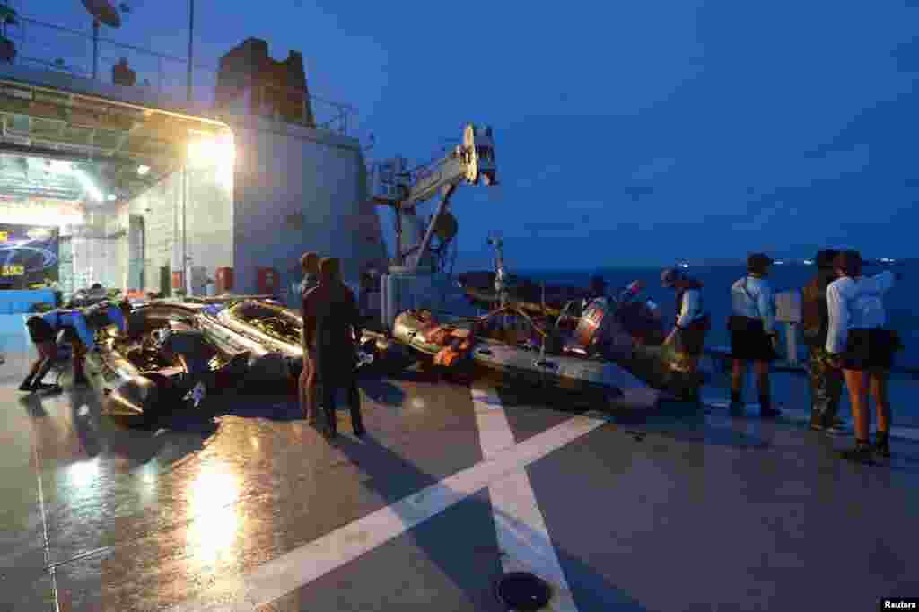 FILE - Indonesian navy divers are seen on board their vessel preparing for an underwater mission in the Java sea January 9, 2015.