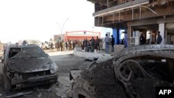 Iraqis gather at the site of a car bomb in Mosul, Iraq, Nov. 9, 2018. The previous night's explosion killed three people, the first such attack since jihadists were ousted from the city last year.