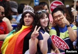 FILE - Participants gesture during a gay pride parade in central Istanbul, Turkey, June 29, 2014.