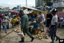 Workers and customers gather at a wholesale food market in Caracas, Venezuela, Jan. 28, 2019.